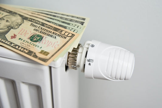 Radiator and dollars on it - saving money on heating concept